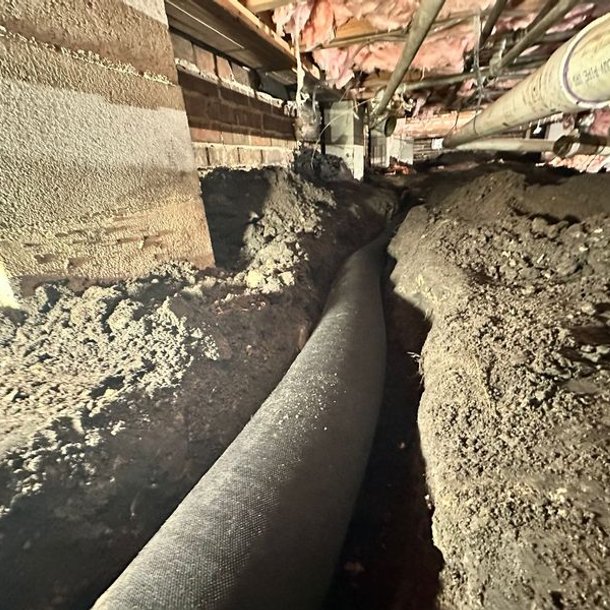 Interior crawl space drainage pipe for water management